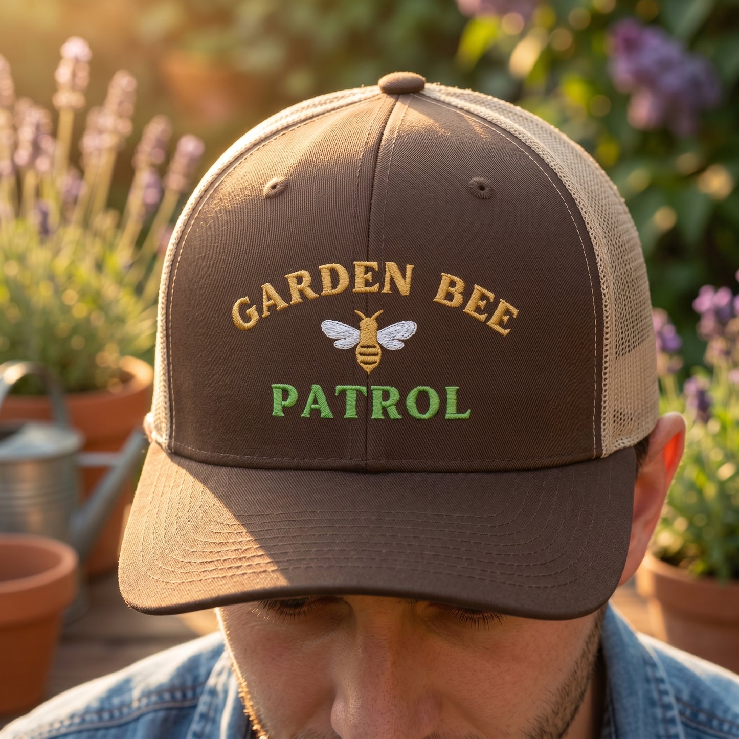 Person wearing a 'Garden Bee Patrol' cap in a garden setting