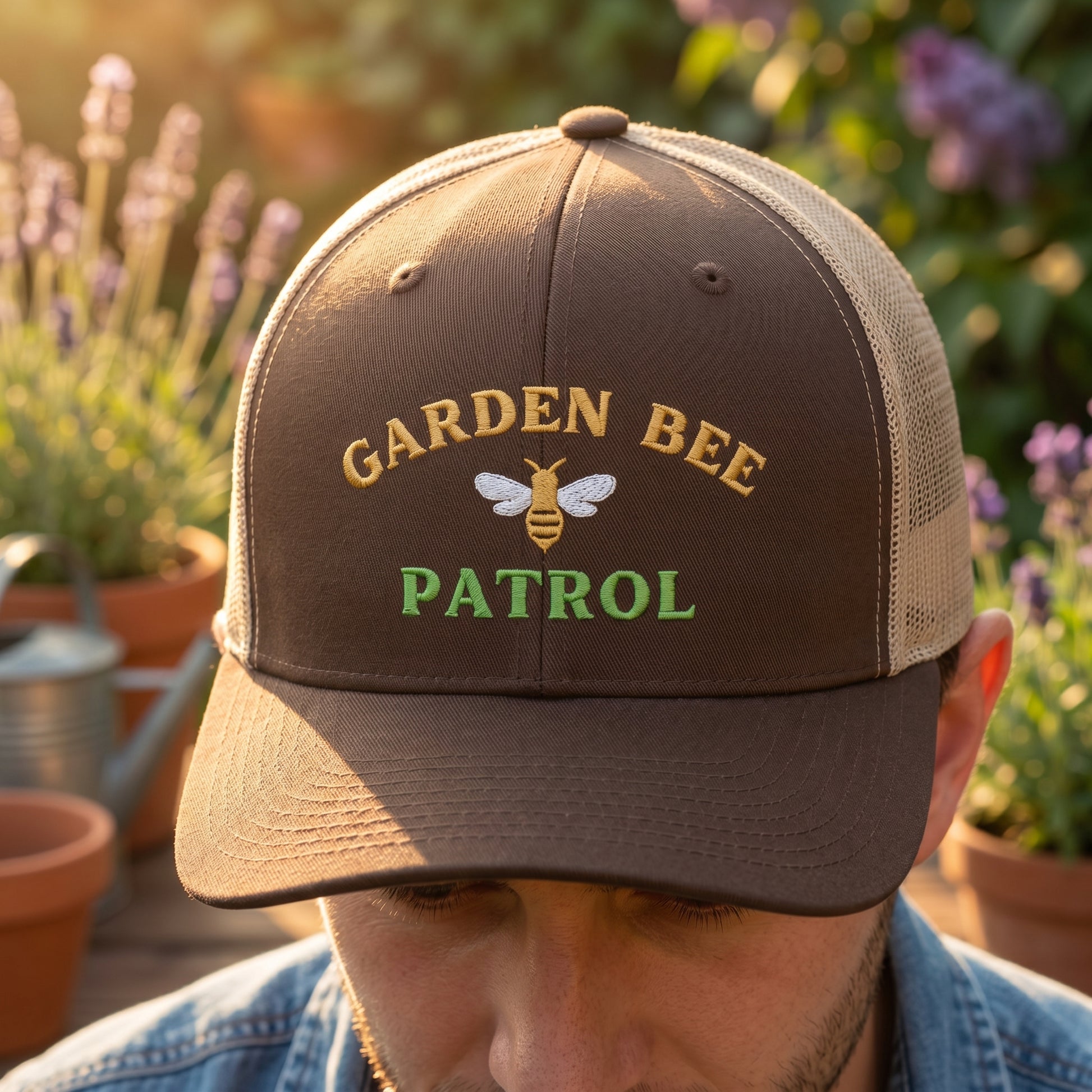 Person wearing a 'Garden Bee Patrol' cap in a garden setting